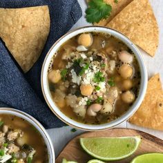 two bowls of white bean and chicken chili with tortilla chips on the side