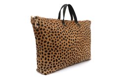 Travel in style with our genuine hair-calf leather cheetah weekender bag. Each bag is beautifully crafted by skilled artisans using premium hand-selected leather. This style features a roomy and fully lined soft cotton denim interior, accessible interior pockets for all your essentials, and a removable crossbody strap. Travel accessories have never looked so chic! (PRODUCT INFO) Size: 17.3" W-top x 14" W-bottom x 10" H x 3" D inches Material: Leopard Calf Hair (cowhide) Leather Size: 44cm W at t Leopard Print Travel Bag With Top Carry Handle, Leopard Print Double Handle Satchel For Travel, Leopard Print Leather Bag With Zipper, Leopard Print Double Handle Travel Satchel, Leopard Print Leather Shoulder Bag With Leather Handles, Leather Shoulder Bag With Leopard Print And Leather Handles, Luxury Calf Hair Shoulder Bag For Daily Use, Rectangular Calf Hair Travel Bag, Luxury Leather Bags In Leopard Print