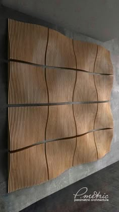 a wall sculpture made out of wood with wavy lines on the top and bottom part