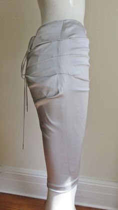 For Sale on 1stDibs - A gorgeous light grey stretch silk skirt from Dolce & Gabbana. It is a pencil style skirt with horizontal ruching across the front and back. There is functional Elegant Ruched Pencil Skirt For Party, Elegant Fitted Pencil Skirt With Gathered Detail, Elegant Draped Stretch Bottoms, Elegant Ruched Pencil Skirt, Elegant Ruched Bottoms For Spring, Elegant Stretch Ruched Bottoms, Elegant Fitted Ruched Draped Skirt, Formal Spring Skirt With Ruched Detail, Formal Fitted Ruched Bottoms