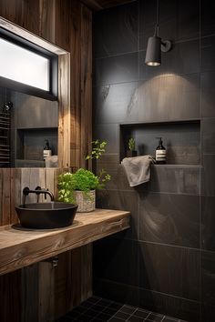 a bathroom with black tile and wooden walls