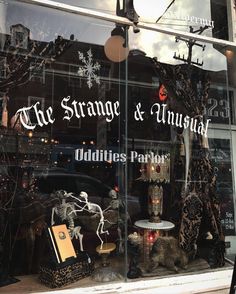 the strange and unusual antiques parlor window display