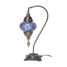 an ornate blue and white lamp on a metal stand with a cord attached to it