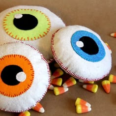 three stuffed eyes are on top of candy