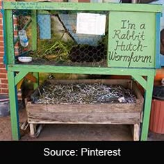 a chicken coop filled with lots of birds in it's cage and some writing on the side