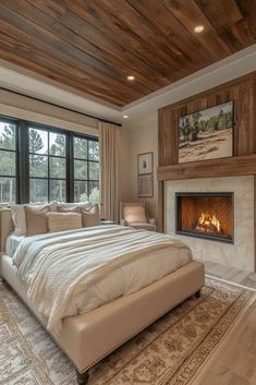 a large bedroom with a fireplace in the center and two windows on either side of the bed