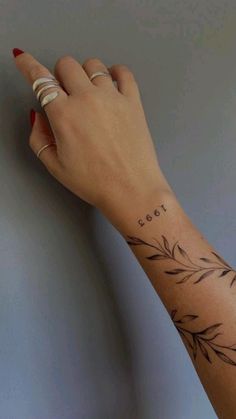 a woman's hand with a small tattoo on her left wrist and the word cool written in cursive writing