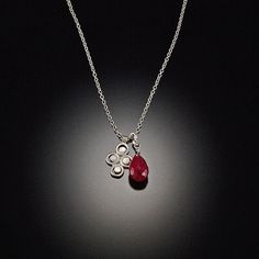 A rich ruby nestled with a small filigree charm make up this lovely necklace. Perfect for everyday sparkle!Charm hangs approximately 1/2 inch.Sterling silver with a matte finish. Elegant Red Charm Necklaces, Elegant Red Charm Necklace, Elegant Nickel Free Oval Pendant Charm Necklaces, Elegant Nickel Free Charm Necklace With Oval Pendant, Elegant Nickel-free Oval Pendant Charm Necklace, Delicate Sterling Silver Birthstone Pendant Necklace, Elegant Birthstone Necklace With Charms, Dainty Silver Ruby Jewelry, Sweet Summer