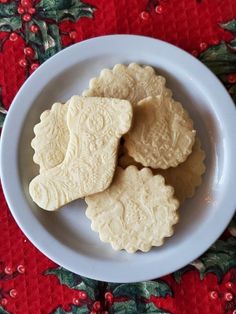 some cookies are on a white plate on a red tablecloth