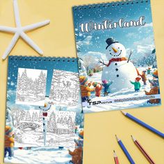 a snowman coloring book and pencils on a yellow surface with starfish nearby