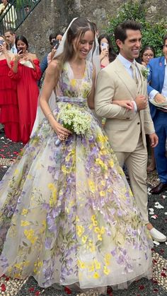 a bride and groom walking down the aisle