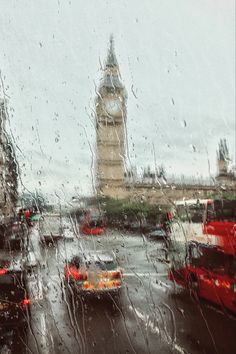 the big ben clock tower seen through a rainy window