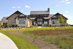 a large house with lots of windows and grass