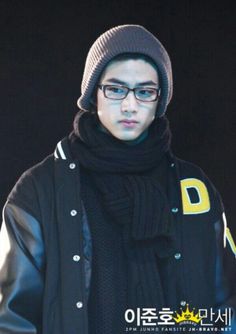 a young man wearing glasses and a beanie