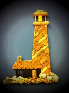 a small house made out of rocks with a light tower on the front and side