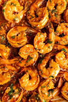 cooked shrimp with sauce and parsley in a pan