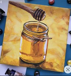 a painting of a jar of honey with a wooden spoon in it on a table