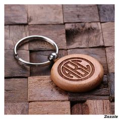 a wooden keychain with a monogrammed initials on it