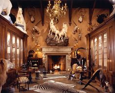 an animal themed living room with zebras, deer heads and other decorations on the walls