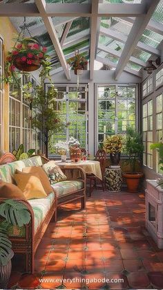 a sun room filled with lots of plants and furniture