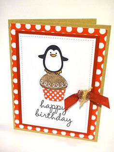 a birthday card with a penguin holding a cupcake