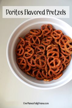 a white bowl filled with fried pretzels on top of a table