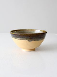 a white and brown bowl sitting on top of a table