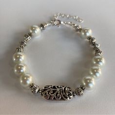 Hand Crafted Pearls & Silver Scroll Bead Bracelet By Desert Beads, 7" Adjustable Stunning Tibetan Silver Filigree Bead Gives A Beautiful Feminine Touch Along With The White Pearls And Several Smaller Silver Beads. This Is A Gorgeous Piece That Can Be Worn Any Time, Any Place. Perfect For Bride, Bridesmaid, Or Mother Of The Bride. The Bracelet Is Finished With A Lobster Claw Closure. Strung On High Quality Jewelry Wire, It Has An Adjustable Chain. I Can Lengthen The Chain For You Or Remove The Ch Adjustable White Pearl Bracelets, Elegant Large Beads Bracelets For Party, Elegant Large Beads Bracelet For Party, Elegant Party Bracelets With Large Beads, Elegant Large Beaded Bracelets For Party, 8mm Pearl Bead Bracelets For Weddings, Elegant Adjustable Beaded Bracelet With Silver Beads, Pearl Bracelets With Silver Round Beads, Classic Pearl Bracelets With Silver Beads