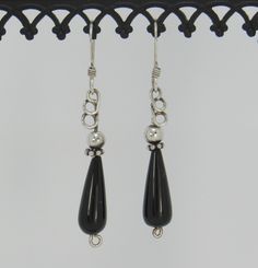 "BE22-Handmade Sterling Silver Earrings with Teardrop Black Onyx and SS Beads. Earrings hang down about 1 3/4\" and have a hand crafted design on top to make them unique. All of my pieces are one of a kind and made by me from start to finish. If you would like more information on my jewelry or me please go to my website at: www.denimanddiamondjewelry.com Thanks for looking! Feel free to contact me with any questions or more info on this piece. Patti" Teardrop Black Beaded Earrings As Gift, Black Beaded Teardrop Earrings For Gift, Teardrop Black Beaded Earrings For Gift, Teardrop Earrings With Black Beads For Gifts, Nickel Free Black Round Bead Earrings, Silver Wire Earrings, Artisan Earrings, Beads Earrings, Casting Jewelry