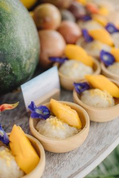 small bowls filled with food sitting on top of a table