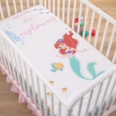 a baby crib with a mermaid theme on it