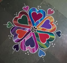 a colorful heart shaped design on the ground