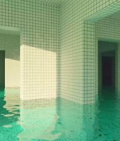 an empty swimming pool with tiled walls and floors