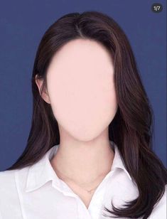 a woman with long dark hair wearing a white shirt and looking at the camera in front of a blue background