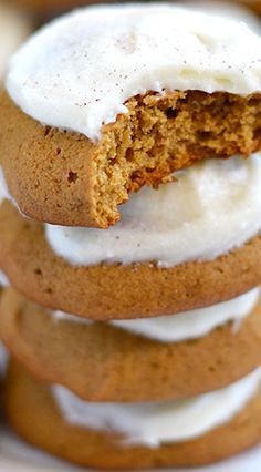 a stack of cookies with white frosting on top and one cookie in the middle