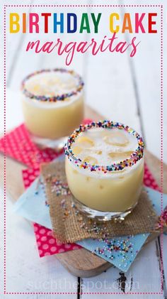 two glasses filled with cake margaritas on top of a table