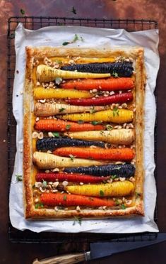 an overhead view of carrots and other vegetables on a baking sheet