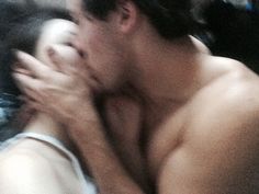 a blurry image of a shirtless man and woman