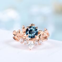 a blue diamond ring with leaves on it