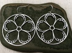 These are so unique and cool!  Big silver flower hoop earrings.  They are modern and whimsical.  Eye catching and versatile.  Dress them up or down.  The earrings measure 1 3/8” long by 1 3/8” wide and are made from plated silver.  They hang from simple silver ear wire hooks.  Overall drop length is 1 1/2”.I have a matching necklace in my shop if you would like the whole set.  Here is a direct link.........Thanks for stopping by!  Please take a moment and visit the rest of my Etsy store.  I have Spring Flower Charm Hoop Earrings As Gift, Spring Hoop Earrings With Flower Charm As Gift, Spring Gift Hoop Earrings With Flower Charm, Spring Hoop Earrings As Gift, Small Hoop Earrings For Spring, Gift, Small Hoop Earrings For Spring Gift, Small Hoop Earrings For Spring Season As A Gift, Small Hoop Jewelry For Spring Gift, Spring Gift Jewelry: Small Hoop