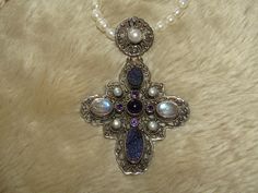 "A beautiful, ornate sterling silver cross with genuine pearls, amethyst, moonstone and titanium druzy, suspended on an 18\" long strand of genuine freshwater pearls. Stamped 925 India and NB on the back of the pendant. This pendant is much more stunning person and quite the statement piece!! In excellent condition." Silver Cross Jewelry With Pearl Drop, Silver Cross Jewelry With Pearl Pendant, Silver Cross Jewelry With Natural Stones, Flower Pedals, Peridot Necklace, Sterling Silver Flowers, Sterling Silver Necklace Pendants, Sterling Silver Cross, Genuine Turquoise