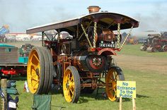 an old fashioned car on display in a field