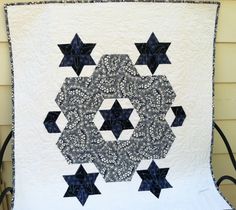 a black and white quilt with stars on it