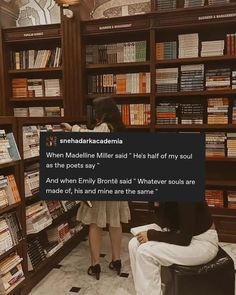 two people sitting in front of a bookshelf with many books on the shelves