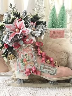 a pair of pink boots sitting on top of a white table next to christmas decorations