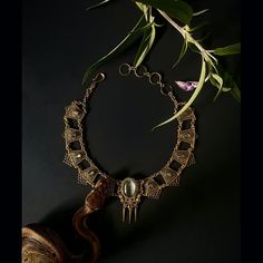 This statement piece rings with mystery and glamor.  This amulet is made from the skin shed of our sweet and pampered ball python, Tutu.  When a snake sheds her skin, it’s a powerful reminder that we have the ability to change old patterns and create a new version of ourselves. A piece of Tutu’s shed resides under glass and is set on top of a colored paper to bring out the beautiful texture of her scales. This pendant features a Tutu-shed centerpiece surrounded by 12 labradorite cabochons on fil Spiritual Metal Jewelry In Snake Shape, Elegant Handmade Snake-shaped Jewelry, Spiritual Snake-shaped Metal Jewelry, Elegant One Of A Kind Jewelry For Ceremonial Use, Luxury Bronze Metal Jewelry, Antique Gold Snake-shaped Jewelry, Adjustable Luxury Snake Jewelry, Engraved Metal Snake-shaped Jewelry, Bronze Snake-shaped Jewelry For Gift