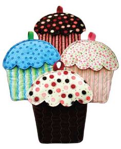 four different colored cupcakes with polka dots on them