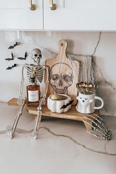 a kitchen counter topped with halloween decorations and skeletons