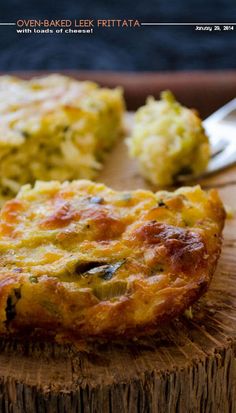 an omelet is sitting on top of a wooden cutting board with a fork