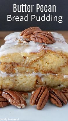 two pieces of butter pecan bread pudding stacked on top of each other with pecans